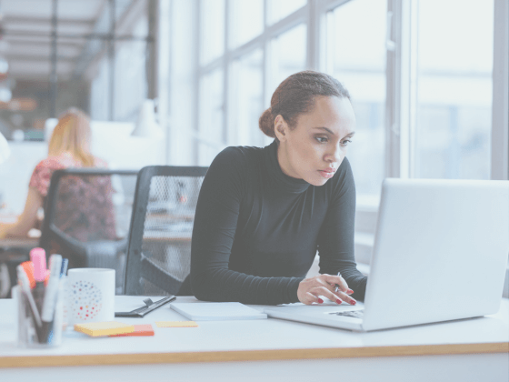 In this image a woman is looking at a marketing calendar.