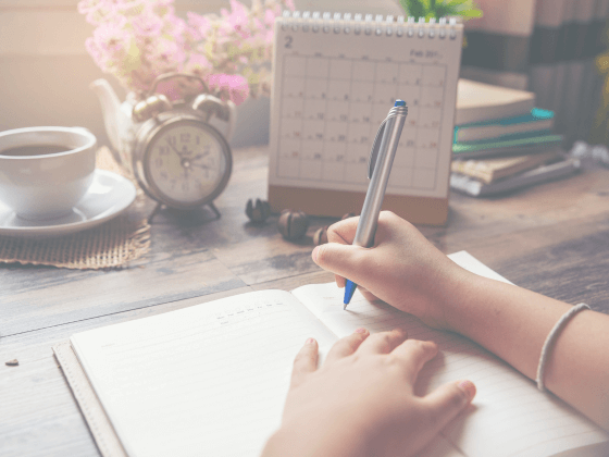 This image shows a person planning their marketing campaign calendar