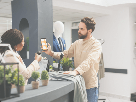 This image shows a man using the discount he received from a retailer via SMS landing pages.