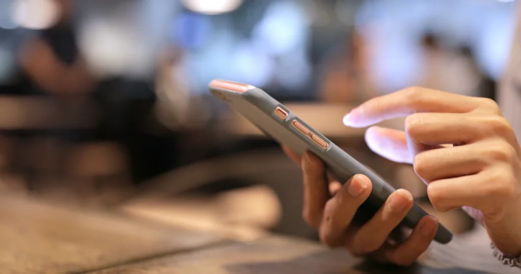 A hand holding a mobile phone.