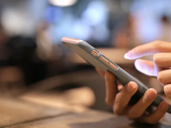 A hand holding a mobile phone.